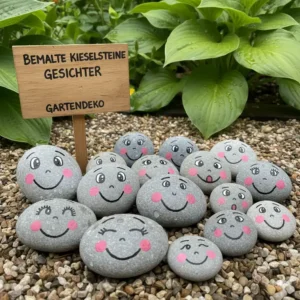 Bunt bemalte Gartendeko Kieselsteine mit verschiedenen Mustern und Gesichtern als DIY-Idee.